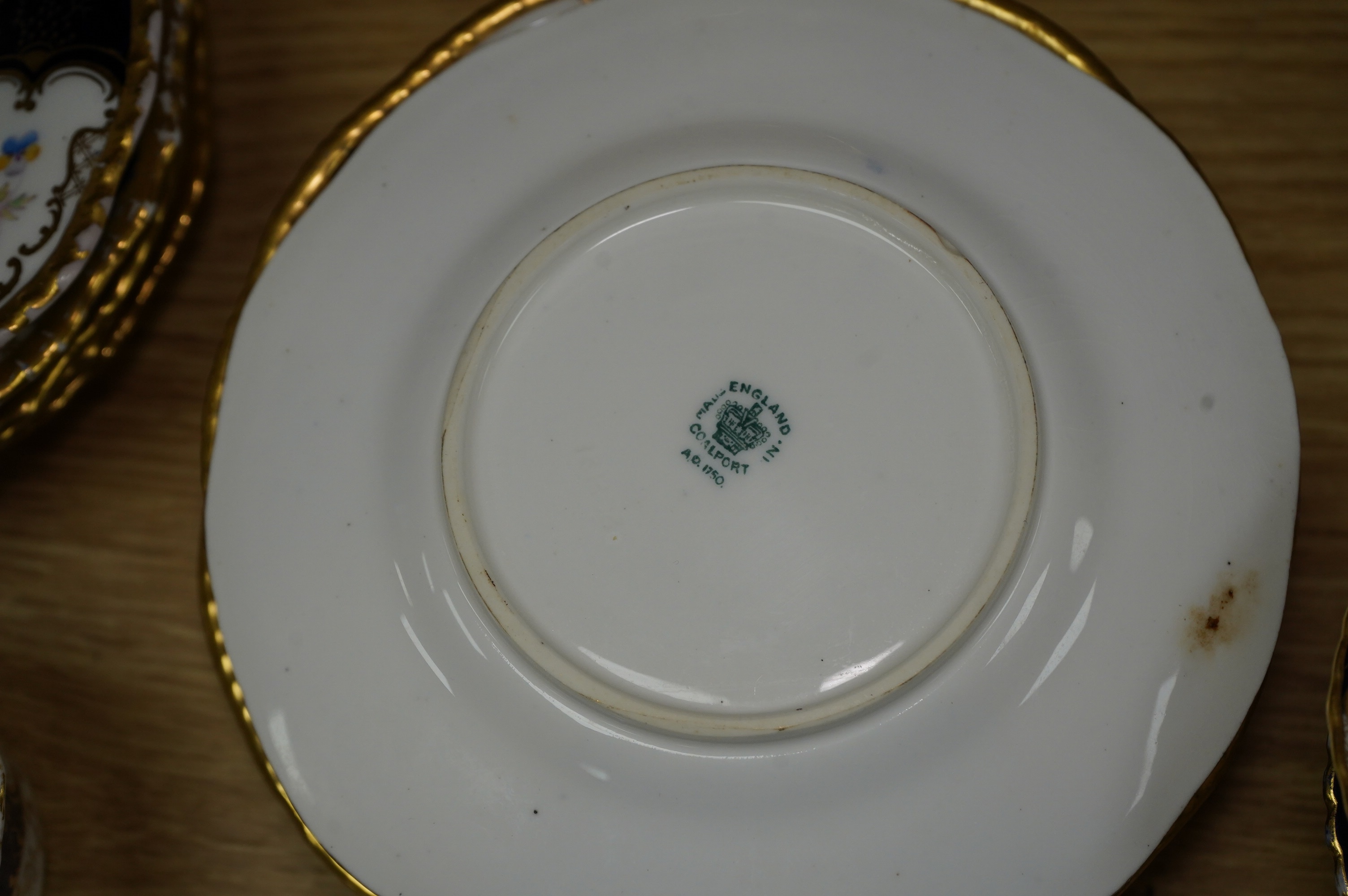 A late 19th/early 20th century Coalport blue and gilt bordered floral painted part tea and dessert service, largest 32cm wide. Condition - varies